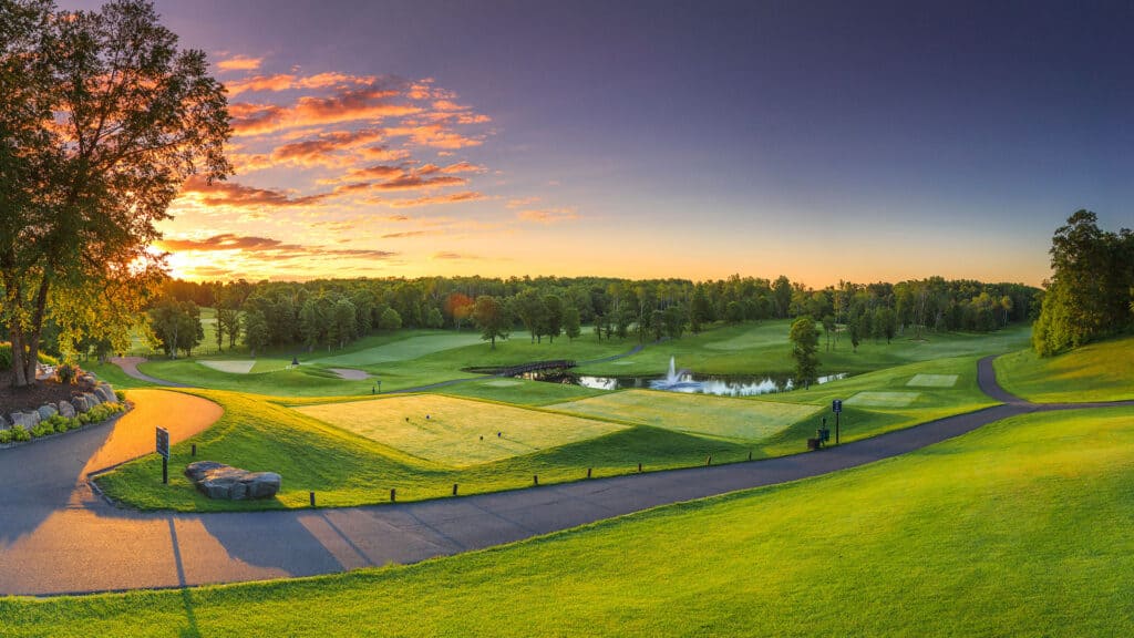 1920x1080 Photo of Golf Course at Grand View Lodge at Sunset with warm lighting, bright green grass, and purple sunset