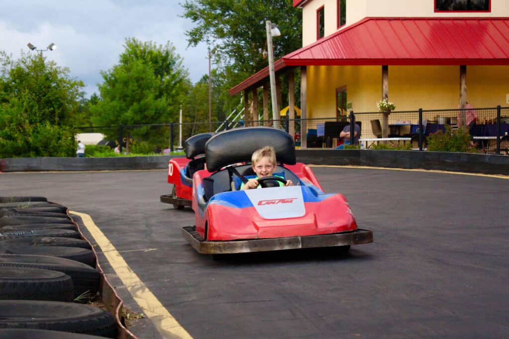 2560x1706 young boy driving go kart around the track at Northland Kart Kountry in Brainerd Minnesota