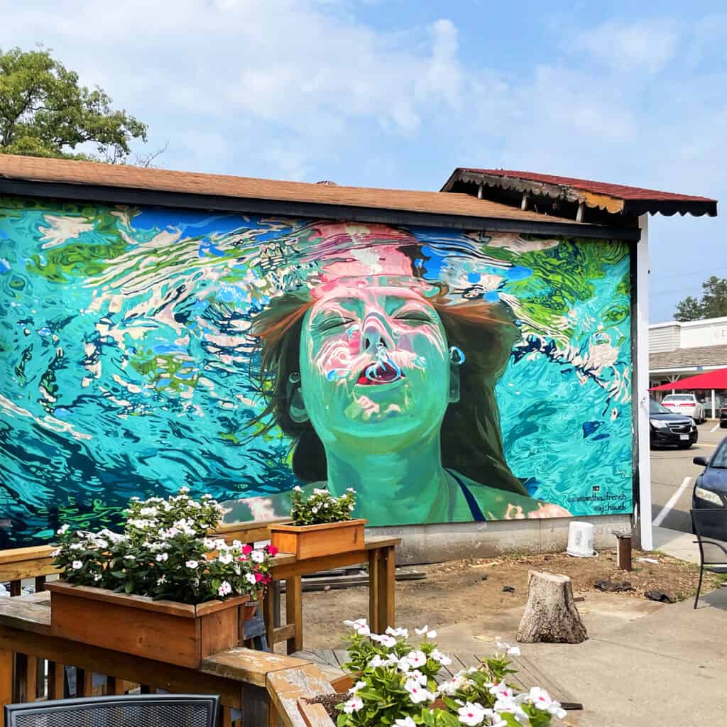 Square Photo of Nisswa Mural showing girl swimming underwater hyperrealist