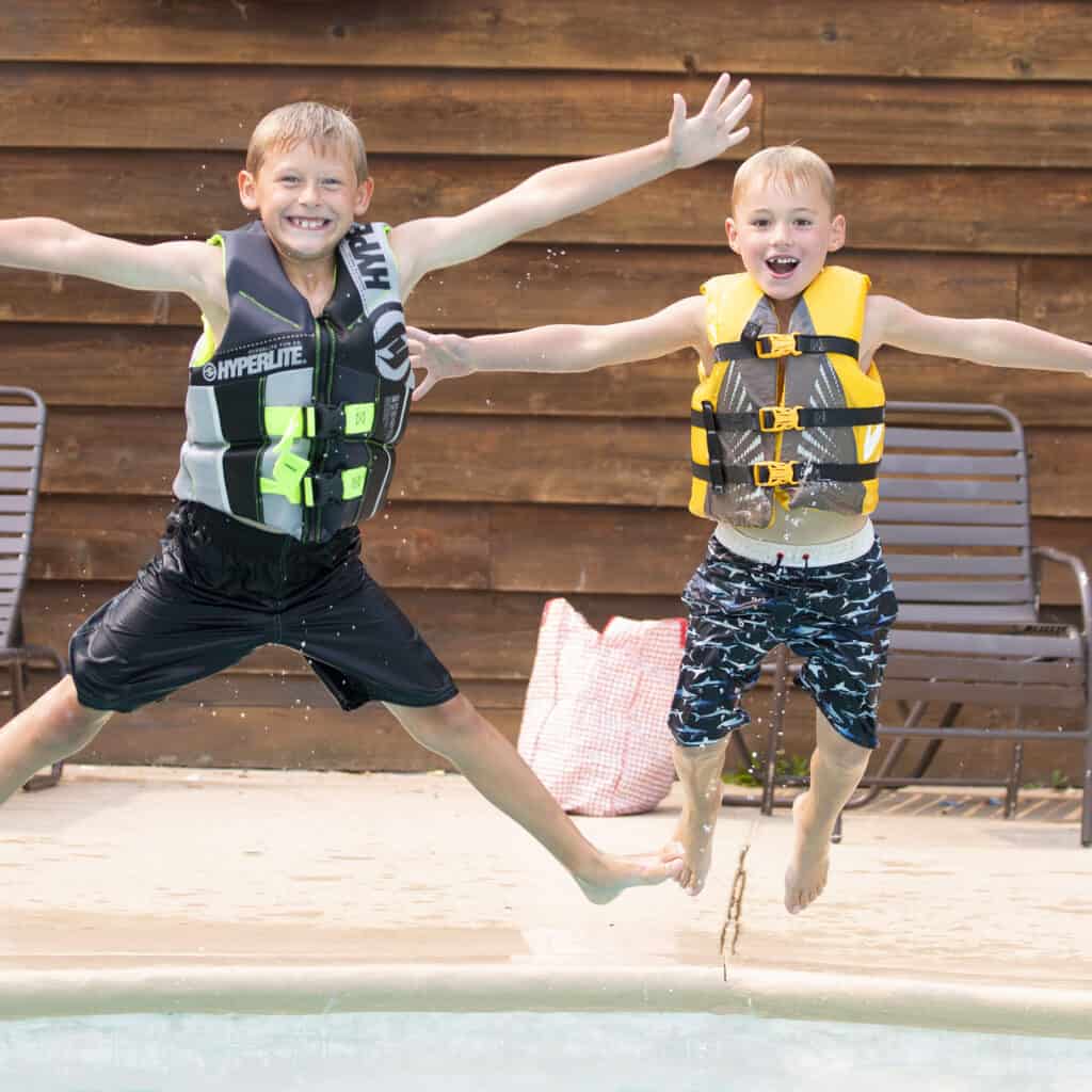 Square photo of kids jumping into a swimming pool at Ruttger's Resort