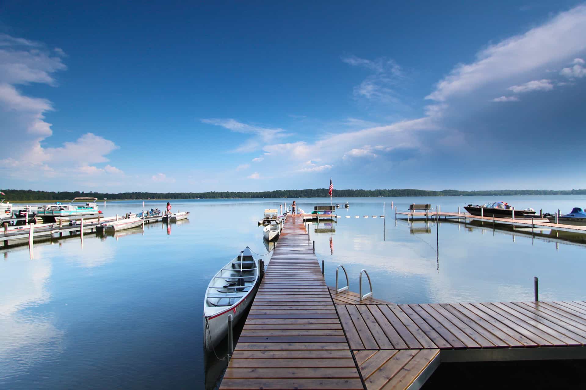 1920x1280 Photo from Eagles Nest Resort of a dock in a lake surrounded by boats on a bright summer day