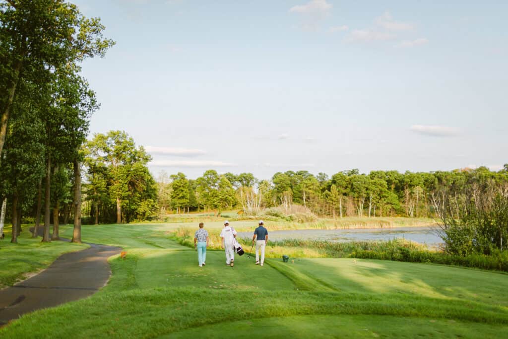 1920x1280 Photo showing three people walking to the next golf hole at a golf course at Madden's Resort