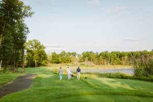 1920x1280 Photo showing three people walking to the next golf hole at a golf course at Madden's Resort