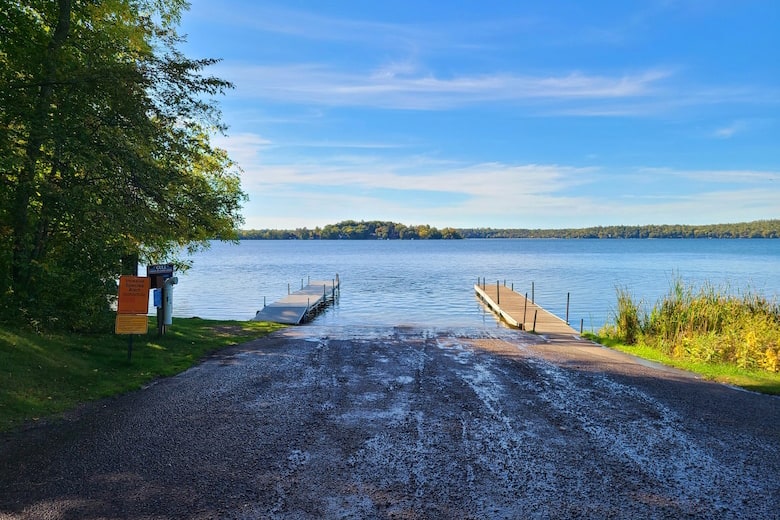 Photo of a boat launch at the Gull Lake Recreation Area on a summer day with two docks in the water.