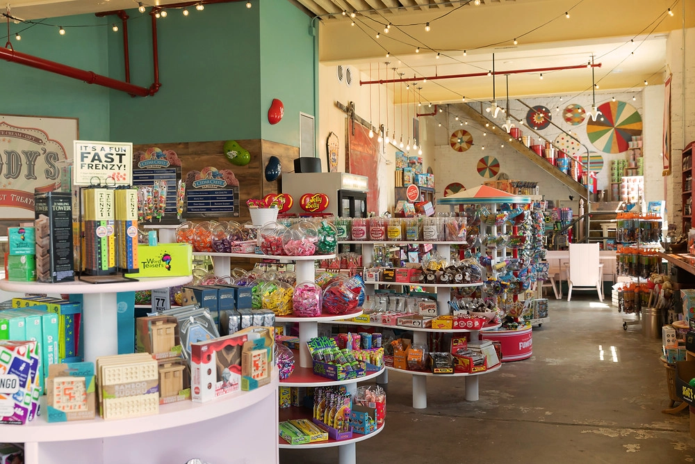 Photo of interrior of Goody's Gormet Treats candy store showing a big room with multiple displays of candy and toys copy