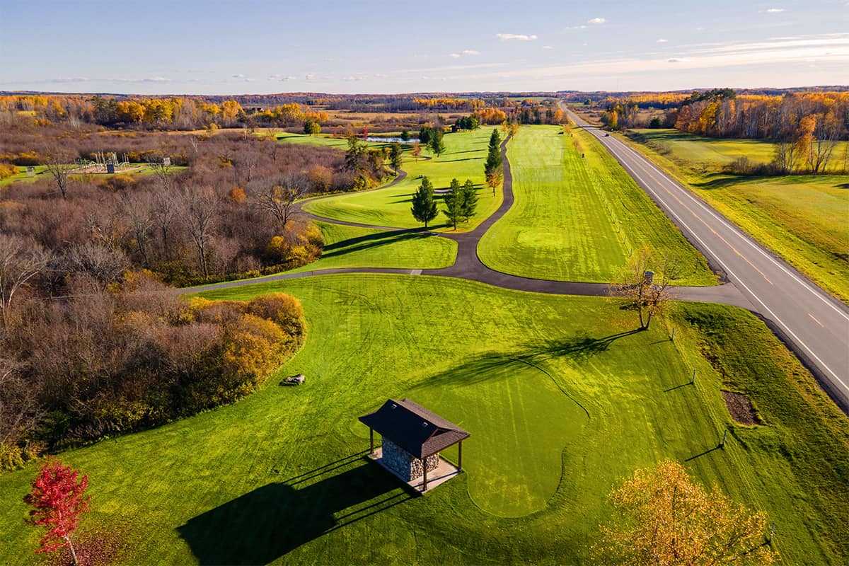 Aerial photo of the Golf Course at The Getaway Adventure Resort showing the large green golf course surrounded by orange trees on a sunny fall day
