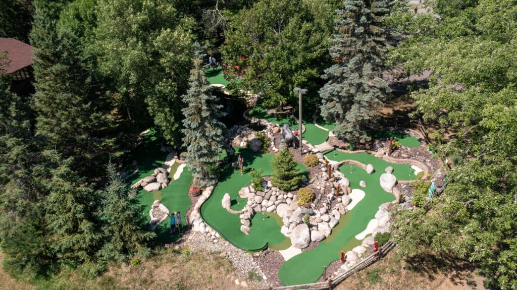Bird's eye view of a mini golf course nestled in the pine trees