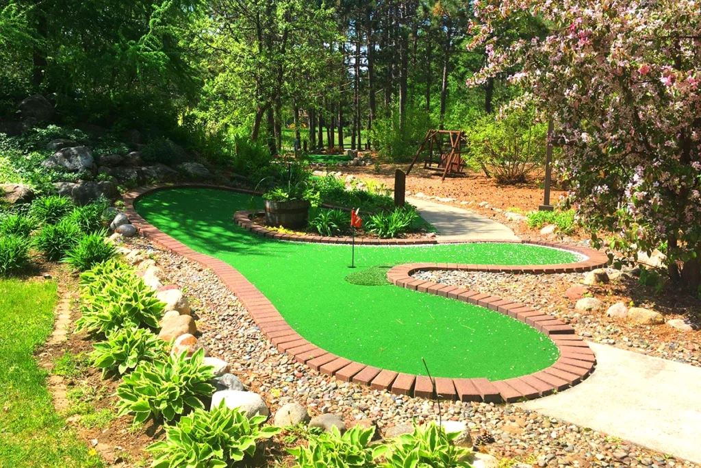 Photo from Wildwedge Golf of a mini golf course on a sunny spring day surrounded by trees and flowers copy