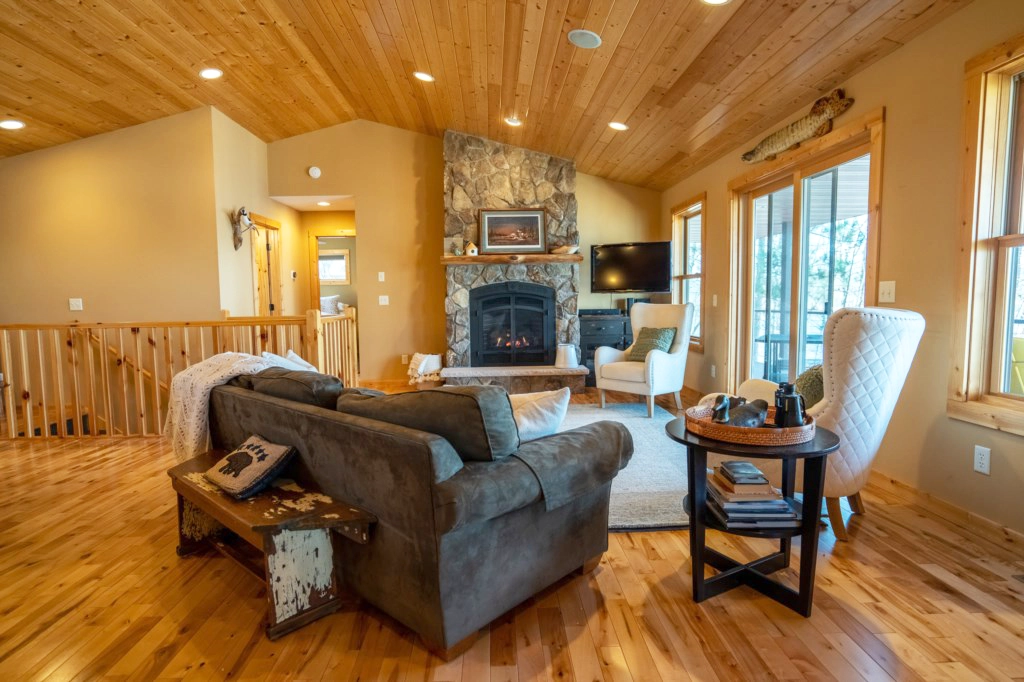 Photo of a living room with stone fireplace at a cabin called Five Pines on Lake Ossawinnamakee