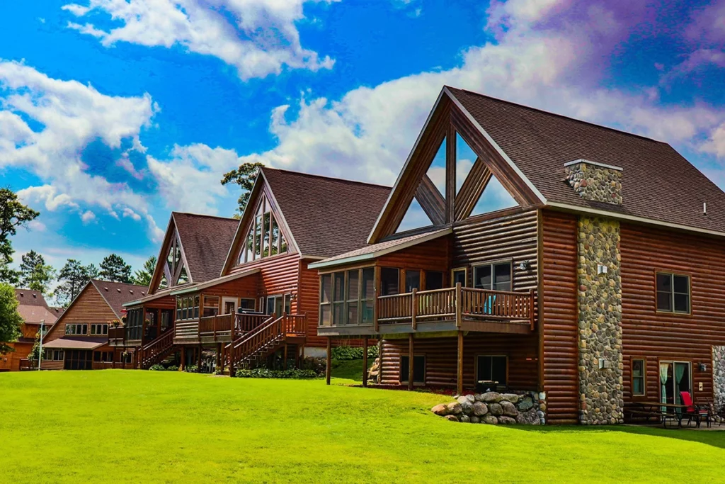 Photo of seveal large cabins on a sunny day at Wilderness Point Resort