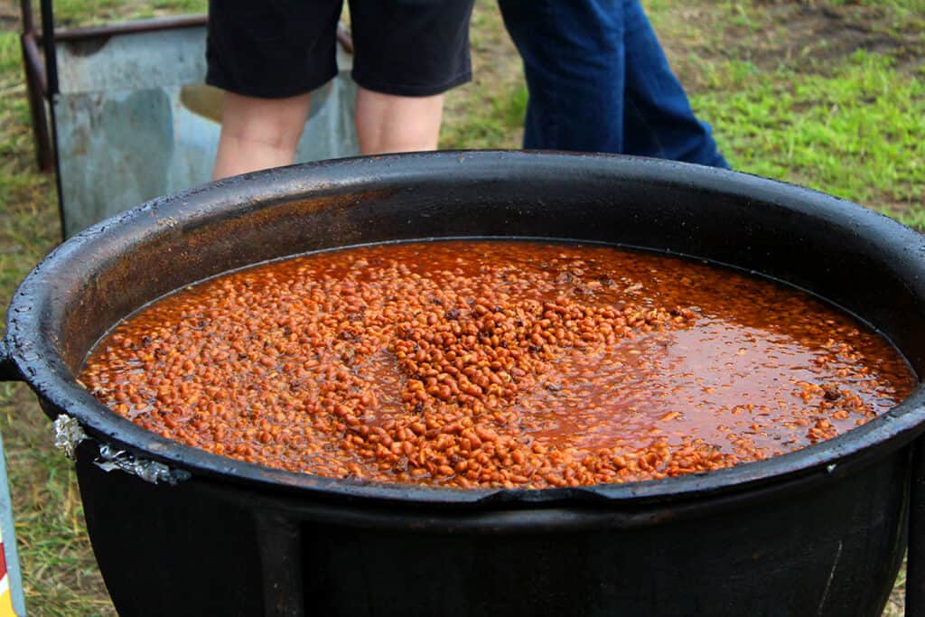 Bean Hole Days in Pequot Lakes showing large iron pot filled with baked beans