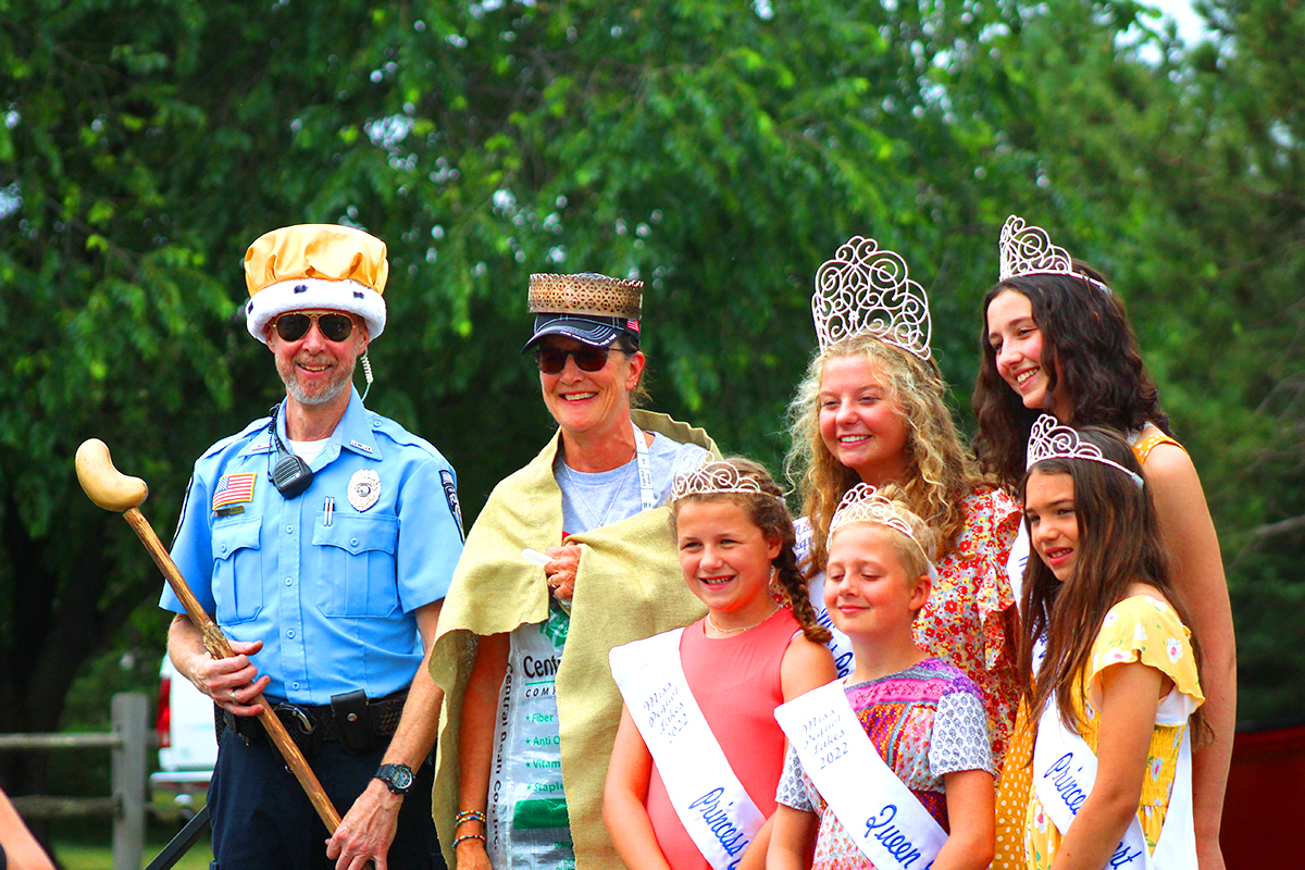 Bean Hole Days in Pequot Lakes showing the corination of King and Queen Bean with the Pequot Lakes pagent royalty next to them