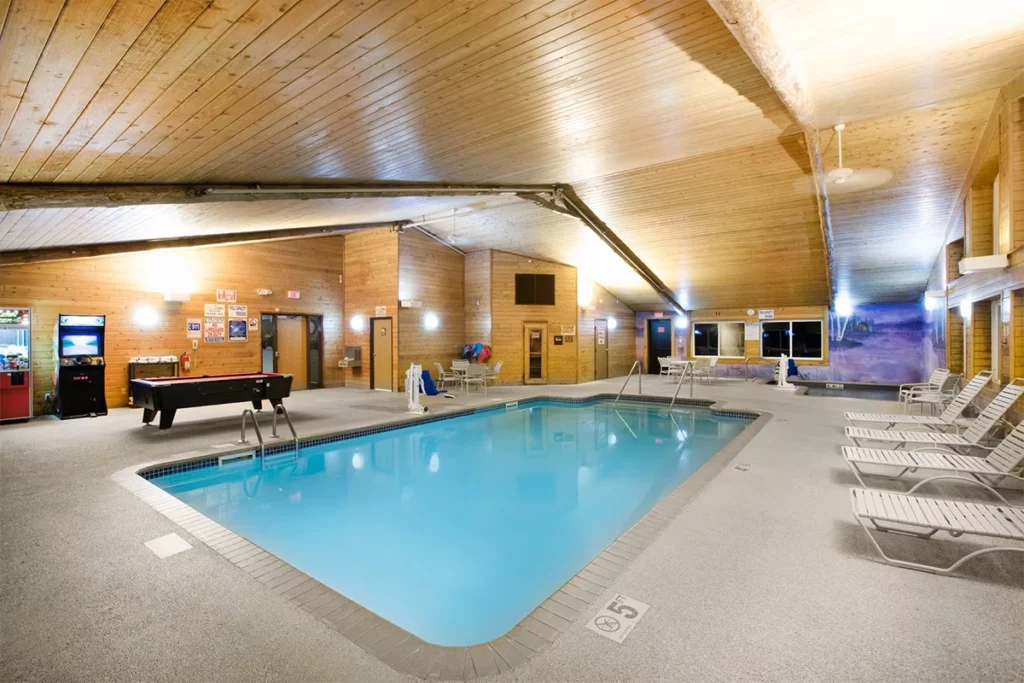 Pequot Lakes Americinn photo showing the large interior pool in a lodge like room with tall ceilings