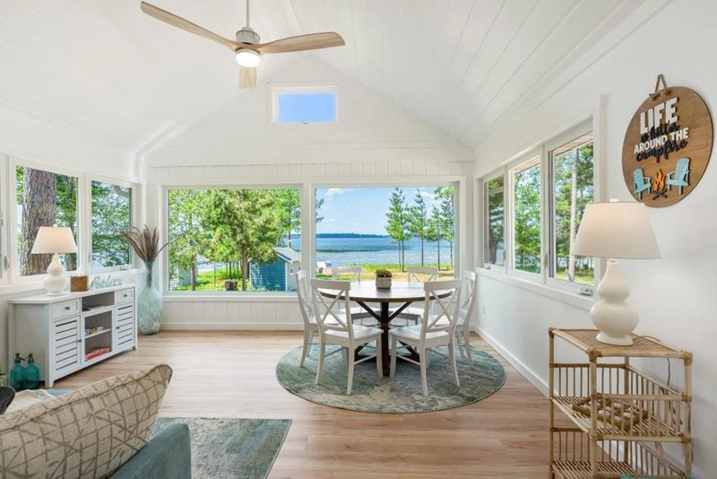 Sunset Beach on Round Lake photo of vacation home rental showing interior of a living room at a beach themed in the summer with a lake in the background copy