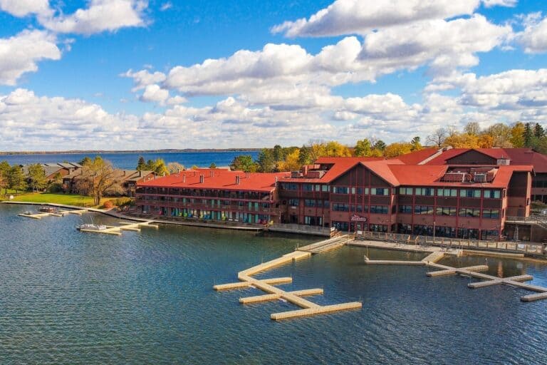 Aerial photo of Breezy Point Resort on Pelican Lake on a fall day with blue skies and white clouds and a lake in the foreground
